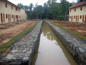 23. Complete row houses. Note the finished drain work. The team cleared the creek for a kilometre to complete this drain 23. Complete row houses. Note the finished drain work. The team cleared the creek for a kilometre to complete this drain